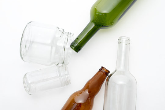 Different types of glass bottles on white background. Recyclable waste. Recycling, reuse, garbage disposal, resources, environment and ecology concept.