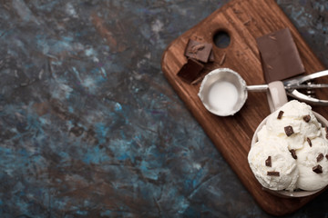 Ice cream balls, scoops and waffle cones on dark background. Advertising space.