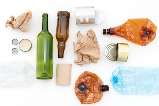Recyclable waste, resources. Clean glass, paper, plastic and metal on white background. Recycling, reuse, garbage disposal, resources, environment and ecology concept