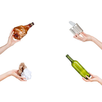 Hands holding crumpled paper, empty glass and plastic bottles, tin can isolated on white background. Copyspace for text. Recycling, reuse, garbage disposal, resources environment and ecology concept.