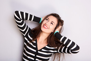 attractive girl smiling with hands in hair