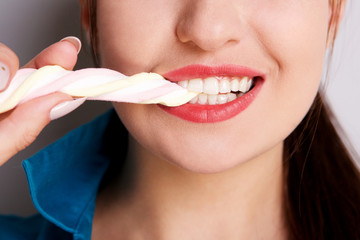 Close up girl eating marshmallow sweet