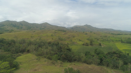 Fototapeta na wymiar Aerial view of mountains covered forest, trees. Cordillera region. Luzon, Philippines. Mountain landscape in cloudy weather.