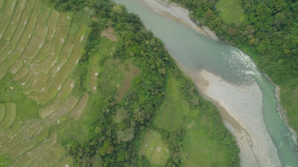 Aerial view of mountain valley in the cordillera, river, rice terraces, farmland in the Philippines, Luzon. Aerial view of mountains covered forest, tree. Cordillera region.