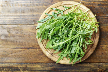 Rucola salad on a wooden background