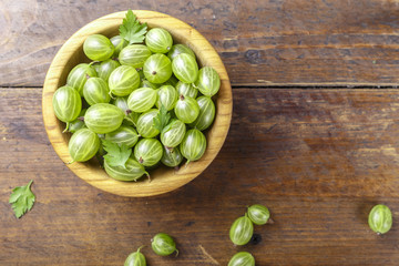 harvest of gooseberry in a wooden plate
