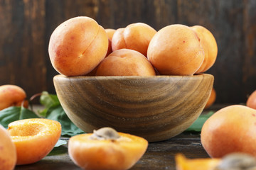 ripe apricots on a wooden background