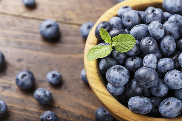 ripe organic bog whortleberry in a wooden plate