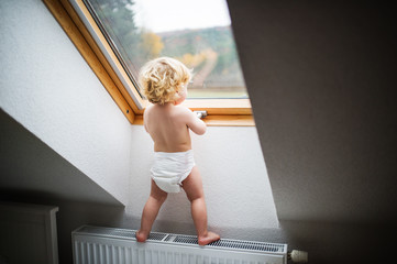 Toddler boy in a dangerous situation at home.