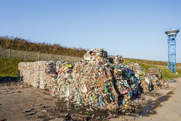 Plastic bales at the waste processing plant. Separate garbage collection. Recycling and storage of waste for further disposal. Business for sorting and processing of waste.