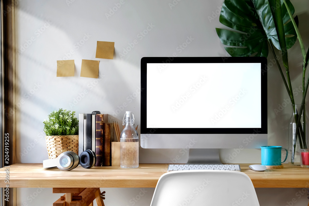 Poster mock up workspace wooden table with blank screen computer, dummy, houseplant. desk workspace with is