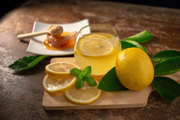 Lemon juice with honey on wooden table,  lemons and sage leaves - Powered by Adobe