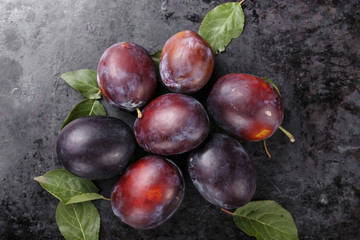 ripe plums on a black background