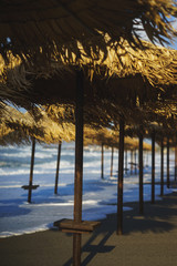 Fototapeta premium Vacation, travel, beach and beach umbrellas from the straw during the tide.