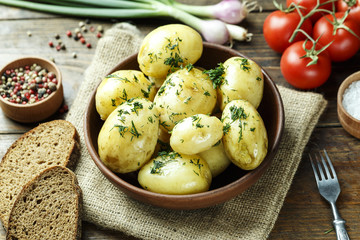 Summer dinner set with potatoes, summer vegetables, with young onions and tomatoes.
