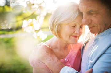 Beautiful senior couple in love outside in spring nature.