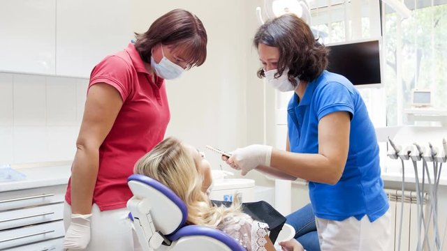 4k video of dentist preparing patient for teeth whitening procedure