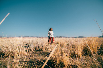 girl staying in  a middle of a field