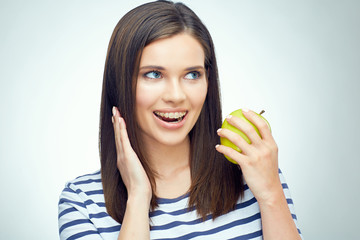 Teenager girl open mouth with dental braces on teeth holding gre