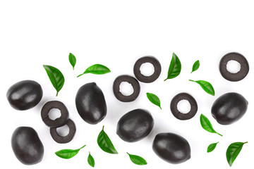 whole and sliced black olives decorated with leaves isolated on white background. Top view. Flat lay pattern