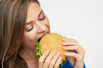 Close up portrait of woman eating burger.
