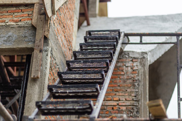 iron stairs set with patterned steps on the old brick background for walk contruction