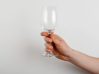 empty glass in hand on white background