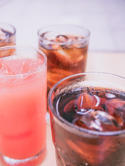 pink color from cool fruit juice and ice with soft focus sparkling water (foreground and background) for summer and fresh