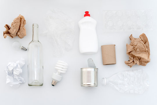 Recyclable waste, resources. Clean glass, paper, plastic and metal on white background. Recycling, reuse, garbage disposal, resources, environment and ecology concept