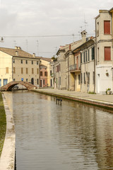 old houses and canal, Comacchio, Italy