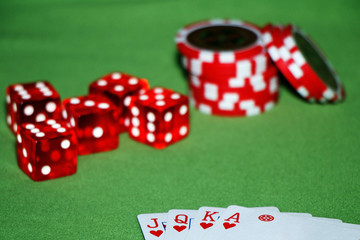 Casino. Cards, chips, blocks on a green table