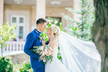 Bride and groom at wedding Day walking Outdoors on spring nature. Bridal couple, Happy Newlywed...