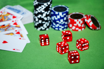 Casino. Cards, chips, blocks on a green table