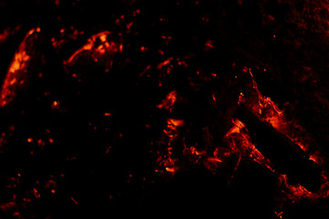 Fototapeta na wymiar Smoldering coals on a black background