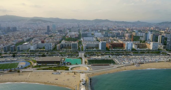 Barcelona city skyline aerial view with modern buildings by the beach, Spain. Sunset light