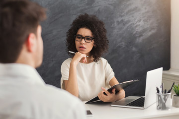 Couple of young colleagues work at modern office