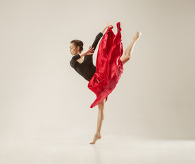 Modern ballet dancer dancing in full body on white studio background. © master1305