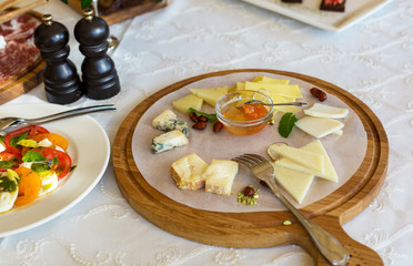 Different type of cheese on the wooden plate, cuisine, healthy food