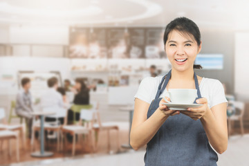 Asian barista or waitress present coffee cup