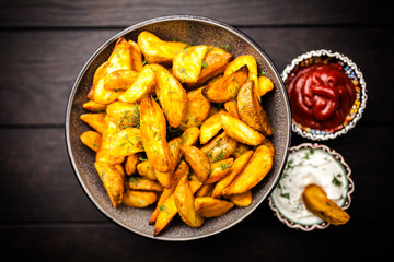 Baked potato fries on wooden table