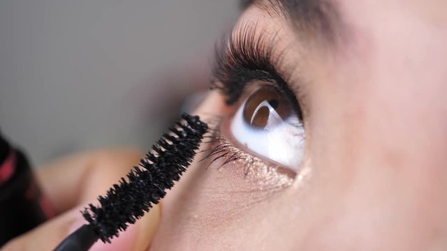 beautician using mascara brush makeup beauty eyelash