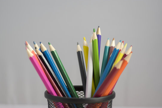 Close up of wooden colorful pencils, group of scattered crayons, isolate od white background