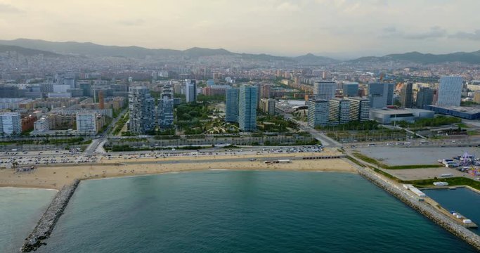 Barcelona skyline aerial view with modern buildings by the coastline, Spain. Late afternoon light