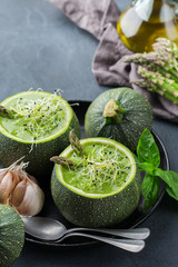 Seasonal creamy asparagus spinach soup served in a round zucchini