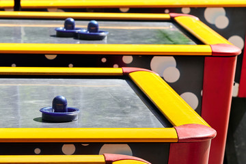 Several air hockey table in the park outdoors.