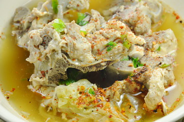 spicy boiled pork bone dressing cayenne pepper soup on bowl