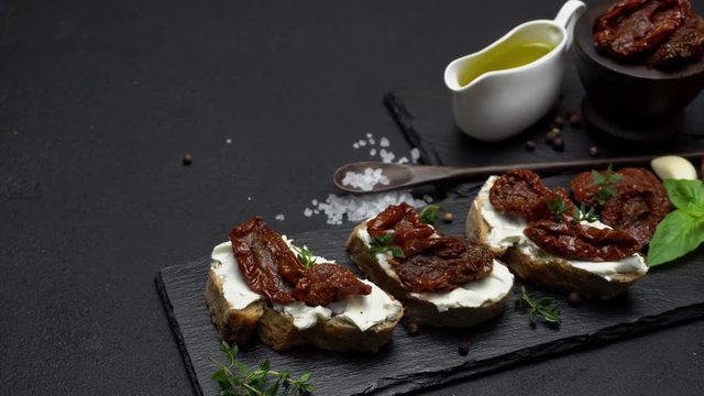 bruschetta with Canned Sundried or dried tomato halves on stone serving board