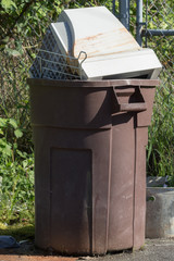 Garbage can with an old computer CRT monitor