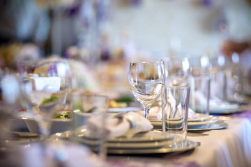 Beautiful table setting with crockery and flowers for a party, wedding reception or other festive event.