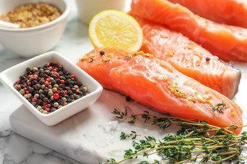 Fresh salmon and ingredients for marinade on marble board